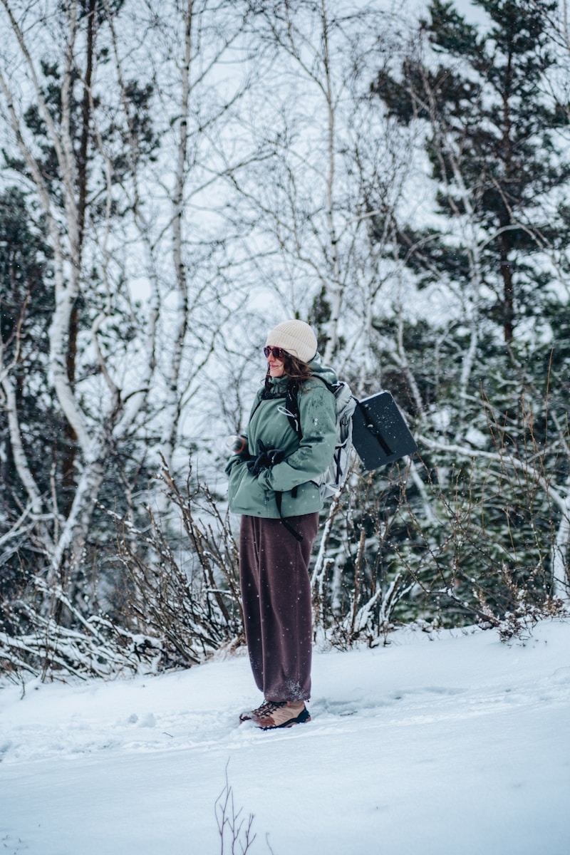 A person standing in the snow with a backpack